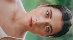 Blue eyed model posing tropical beach vertical video portrait. Serious young girl looking camera on turquoise pond nature summer day close up. Yogini relaxing outdoor. Paradise jungles landscape place