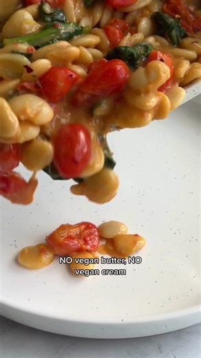 NO BUTTER, NO CREAM, Creamy Butter Beans! What’s the secret? Hummus and the liquid from the canned beans, plus juice of smashed tomatoes. 10 minutes, 6 ingredients. Let me know of you make this! I’m having this for lunch today! #veganlunch #butterbeans #easyveganrecipes #quickrecipes #plantbasedrecipes Ingredients: Drizzle of olive oil 3 large garlic cloves, sliced ½ pint cherry or grape tomatoes ¼ teaspoon crushed red pepper flakes, or to taste 1 (15-ounce) can butter beans, drained, reserving