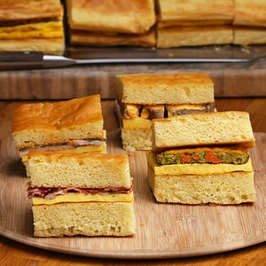143K views · 145 reactions | A 4-flavour giant sheet pan breakfast sandwich to satisfy all of your family's cravings.  FULL RECIPE: https://tasty.co/recipe/4-flavor-giant-sheet-pan-breakfast-sandwich | Tasty UK | Facebook