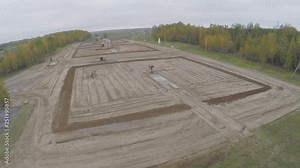 Industrial oil pump jack working and pumping crude oil for fossil fuel energy with drilling rig in oil field. Aerial photography slide. View from the drone on the forest.