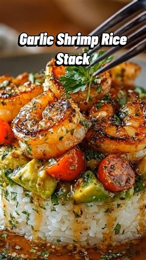 Garlic Shrimp Rice Stack Pan-seared garlic shrimp stacked over herby rice with avocado and tomatoes. Fresh, buttery, and perfect for dinner. Ingredients Large shrimp, peeled and deveined Cooked white rice (short or medium grain works best) Avocado, diced Cherry tomatoes, halved Fresh parsley, finely chopped Garlic, minced Olive oil Butter Lemon juice Paprika Salt and black pepper Method I started by seasoning the shrimp with paprika, salt, and pepper, then seared them in a hot pan with olive oil