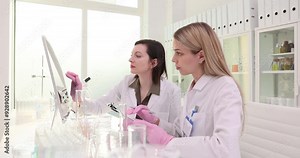 Two scientists work in a touch screen computer lab Stock Video