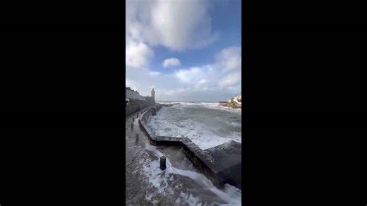 Powerful waves slam into Porthleven harbour during Storm Chandra in Porthleven, Cornwall, UK
