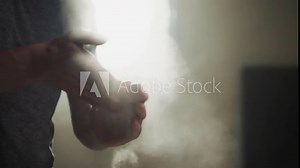 Fighter uses talc powder to dry palms in gym closeup. Young boxer prevents hand sweating with talcum in martial arts club slow motion. Athletic products