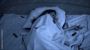 Young sleeping woman. Fast motion effect. Night dark light.