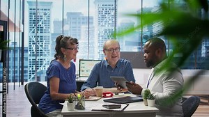 Senior citizens meeting with a financial advisor to plan their retirement, discussing pension plans and savings growth. Establishing financial goals with agency broker consultant. Camera B.