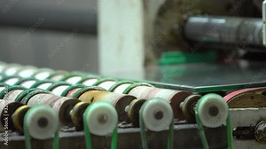 Square glass panel on the factory conveyor roller. Transporting glass elements with multiple spinning round rollers. Conveyor in glass factory.