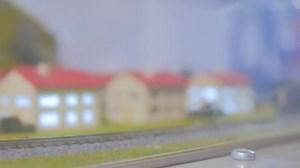 Toy hobby railroad layout with train and houses