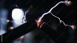 Electric arcs forming between two electrodes, close-up of electrical discharge and plasma concept, science, electricity.