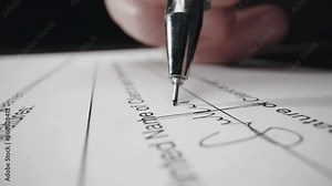 Close-up of male hand putting signature on the contract, signing report after checking information.