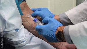 Doctor taking a blood sample from the patient - concept of PRP injections and testing