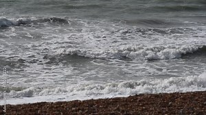 Close up of waves from Atlantic Ocean crashing onto the shore, Slow Motion.