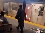 Cop walks past woman set on fire on subway as suspect watches