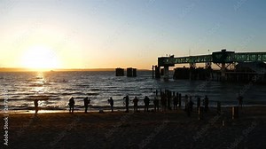 Beautiful night to enjoy a sunset at the edge of the pacific northwest coastline of the Puget Sound at Edmonds beach, Group of people gather to make memories and take pictures and Video of the sunset.