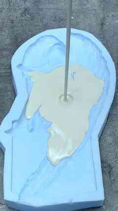 Pouring Plaster Into a Silicone Mold for Casting