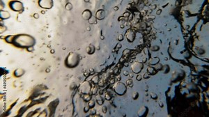 Funny dog dives, in the water of Montana lake. Underwater, slow-motion, shooting of swimming. German shepherd in see, turquoise water.