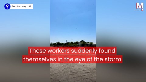 Workers get caught in the middle of a giant dust devil