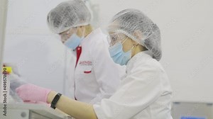 Lab workers in the laboratory. The doctor in the hospital takes notes. Working process in a modern medical laboratory