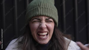 Young angry woman shouting arguing feeling betrayed, cheated and frustrated. Close up female looking at camera with negative emotions and aggressive behavior. Youth frustration issue