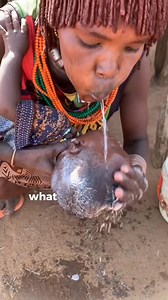 Spit washing in the Hamer tribe refers to a traditional practice where a person takes a small sip of water and gently spits it out, often as part of ritual cleansing or blessing. | Omo Valley Tours and Travel enjoy your summer time