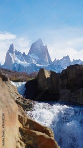 Mount Fitz Roy showing though secret waterfall in Patagonia Argentina, El Chalten town. Vertical shot