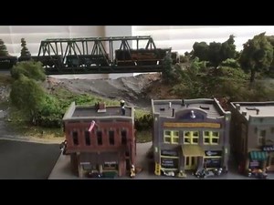 N SCALE TRAIN LAYOUT WITH FINELY DETAILED BUILDINGS, TUNNEL AND BRIDGE