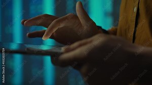A technician analyzes and tests a server room robot that manages open source artificial intelligence robot processes. Close-up of an engineer's hand working with a tablet