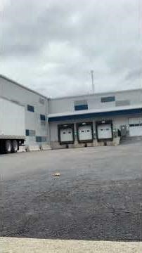 “Tractor trailer backing off side street into corner dock.”