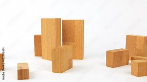 Wooden blocks are placed and stacked like a chart or a staircase, set against a white background