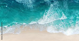 Aerial view of sandy beach and ocean with waves