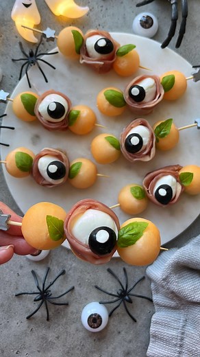 65K views · 181 reactions | Mozzarella Eyeball Skewers. Deliciously eerie skewers for your Halloween gatherings made with bocconcini, prosciutto, olives, and cantaloupe. Top with sea salt, olive oil and balsamic glaze. Yum! Head to my website (food-bites.con) for more spooky ideas. #halloweenfood #halloweenideas #spookyszn #halloweenpartyfood #spookyfood #food52 | Foodbites | Facebook