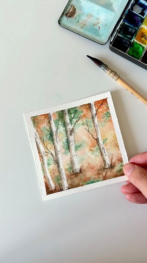 My favorite watercolor trick for painting trees ✨ Here’s a fun masking-tape technique I love using to paint light tree trunks, and this simple trick just made the whole process so much lighter and playful! Now we are just in the perfect season, maybe it’s time the paint a tiny autumn tree landscape yourself 🍁 📹 The full tutorial is now on my YouTube channel 👉https://youtu.be/anh1bZpFc4w. You can find the relaxing painting process and the tips for creating this tiny watercolor. And if you want