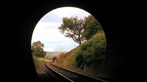 Steam train entering tunnel