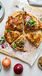 This comforting galette is spiked with the rich sweetness of caramelised onions through the layers of potato, wrapped up in a flaky pastry and served with the crisp freshness of sliced red onion and parsley salad to add a lovely contrast 🧅 @aussieonions Ingredients Galette 2 brown onions, finely sliced 2 tbsp olive oil 2 large Desiree potatoes, thinly sliced 3 tbsp unsalted butter, melted 2 tbsp chopped thyme ½ cup cheddar, grated 1/3 cup parmesan, grated ½ cup mozzarella, grated Salt, pepper 1