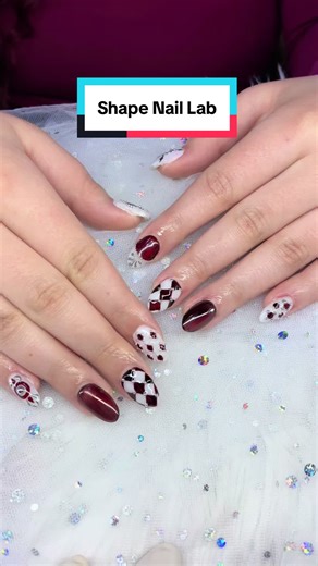 Deep burgundy romance with a twist of checkerboard chic 🤎❤️ Glossy wine tones, crystal details, and playful heart accents — the perfect mix of sweet and edgy for your Valentine vibe. Book your appointment and let your nails do the talking ✨ 💅Shape Nail Lab. 📍39 S Huntington Ave, Hamaica Plain MA 02130. ☎️617-487-5226 #ValentineNails #HeartNails #nailsinspo #bostonnailtech #buildergel
