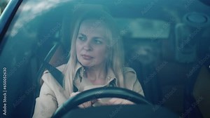 Stressed annoyed woman driver sitting inside broken car. Angry female driver driving a car. Angry young woman late for work and stuck in a traffic jam. Exhausted girl stuck in traffic. Car breakdown