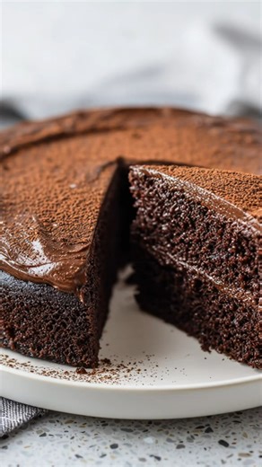 This keto chocolate cake is rich, moist, and made right in the air fryer Keto Chocolate Cake (Air Fryer) Prep time: 10 minutes Cook time: 18 to 25 minutes Total time: 35 minutes Serves: 6 to 8 (one 6 inch cake) Ingredients Cake 1 1/2 cups almond flour 1/4 cup unsweetened cocoa powder 1/2 cup low carb granulated sweetener 1 1/2 teaspoons baking powder 1/4 teaspoon salt 3 large eggs, room temperature 1/3 cup sour cream 1/4 cup melted butter 1/4 cup unsweetened almond milk 1 teaspoon vanilla extrac