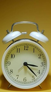 Download An alarm clock on a yellow background for free