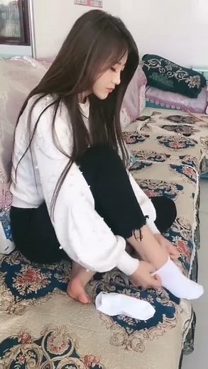 putting on her white ankle socks