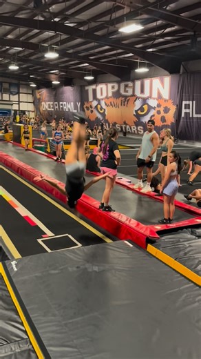 Sean Guzman on Instagram: "The one thing you can gather from my training, is that I’m a huge fan and a big advocate of working front tumbling for various reasons, one being the idea of mastering unidirectional momentum, the other and lesser known is how much an athlete needs to engage the posterior chain (the chain of muscles running along the backside of the body, glutes, hamstring, etc). Here we have of our long time athletes with a nicely executed front handspring front layout. The front hand