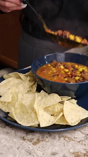 Easy Taco Soup/Chili (Meal in a Bag Demonstration) You will need: 2 cans of no bean chili 1 can of black beans 1 can of chili beans 1 can of corn 1 can of diced tomatoes and green chiles 1 packet of velveeta cheese sauce Open all cans, rinse and drain the black beans. Stovetop: Add all ingredients except for velveeta into a pot, stir, bring to a boil them simmer for 10 minutes. Just prior to serving stir in velveeta cheese sauce. Slow cooker: Add all ingredients into slow cooker, stir, then cook