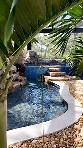This project features natural rock waterfalls, a beautiful spa, an infinity edge, and a massive pool cage. #insanepools #lucaslagoons #backyardgoals | Lucas Lagoons