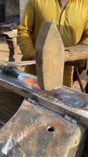 the process of installing red hot rivets on a steel frame #shorts