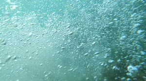 Jumping PoV (Slow Motion Action Camera) from rock into sea underwater and emerged with a sunset view. Sports Lifestyle Hobby Vacation Leisure Activity