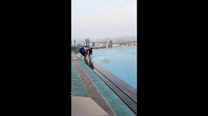 Person falls into swimming pool while filming a swimmer underwater in Guangdong, China