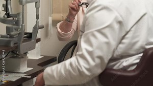 A demonstration video of a professional doctor taking lens for optometrist trial frame to check female patient eyesight. Vision testing for senior people.