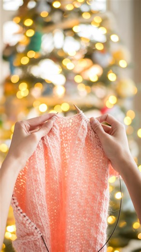 Stephanie Lau @AllAboutAmi on Instagram: "Some cozy knitting by the Christmas tree ✨🎄 {Pattern: Dotty Cardigan, Yarn: The Petite Wool in “Millennial Pink” by @weareknitters 💕} #dottycardigan #weareknitters #knitcardigan"
