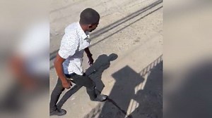 Man caught on video viciously beating woman held by police - Jamaica Observer