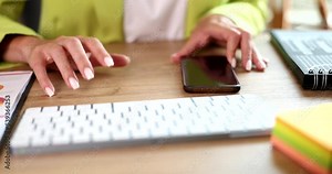 Adult female boss or secretary taps finger on table next to phone