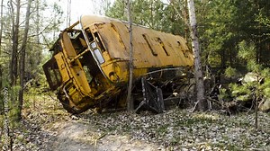 Yellow bus abandoned in the Chernobyl forest. Chernobyl Exclusion Zone